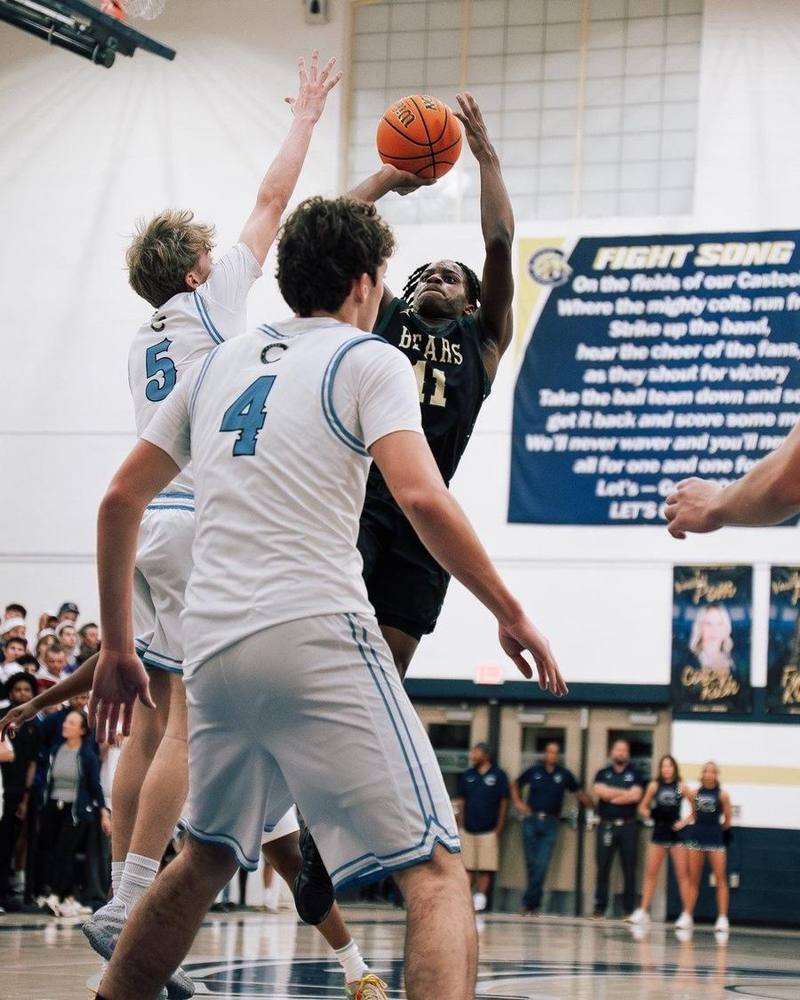 Rising over two defenders